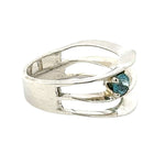 Taxco silver ring from the side with a blue topaz gemstone on a white background