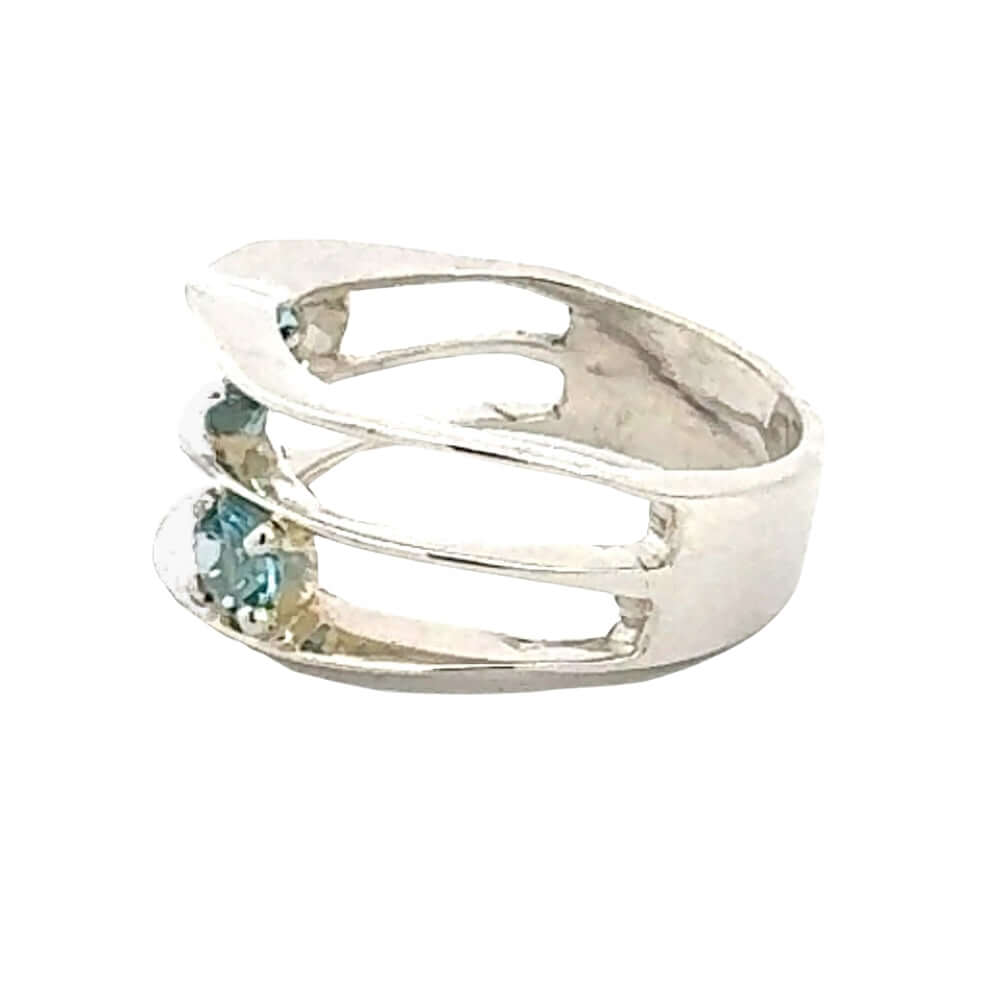 Taxco silver ring with blue topaz from the side on a white background