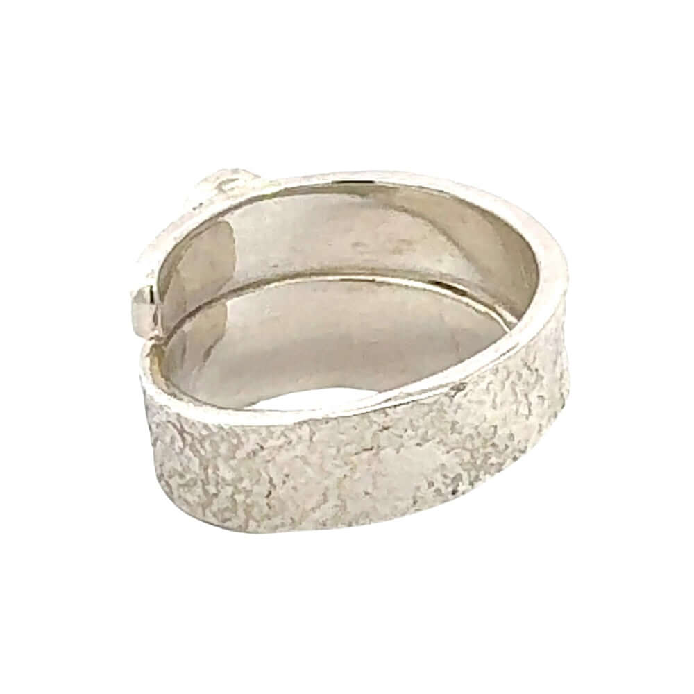 Silver ring with a textured surface on a white background