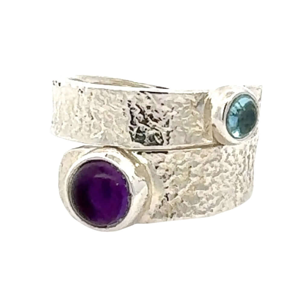 Silver ring with amethyst and blue topaz on a white background