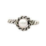 Silver ring with a pearl on a white background