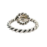 Silver twisted ring with '925' stamp on a white background
