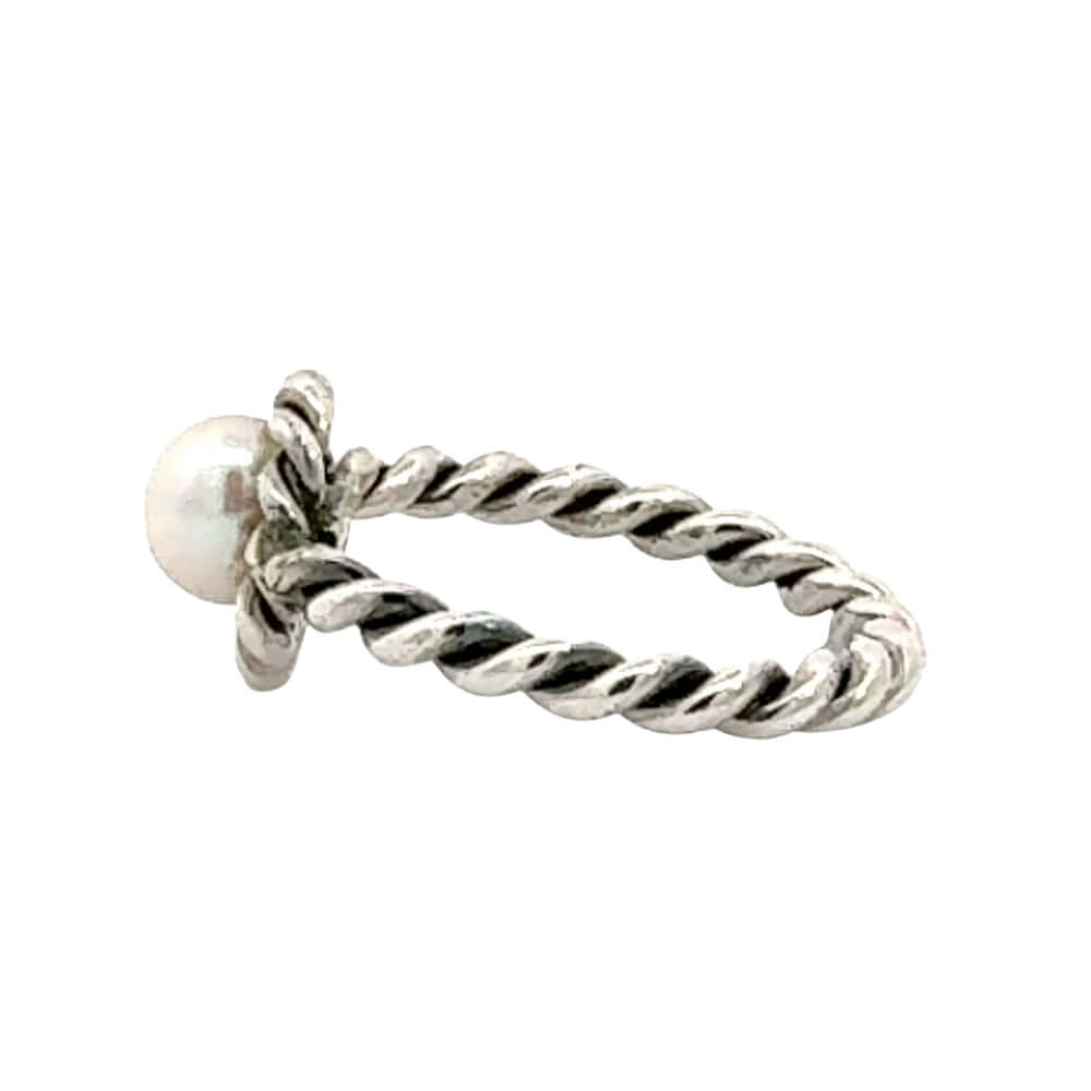Silver ring with a pearl on a white background