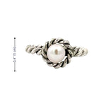 Silver ring with a pearl on a white background and measurements