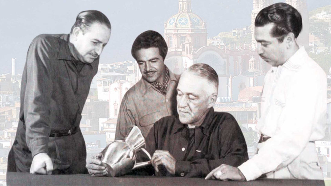 A black and white photo of William Spratling, Antonio Pineda, Hector Aguilar, and Antonio Castillo examining a high quality sterling silver craft.