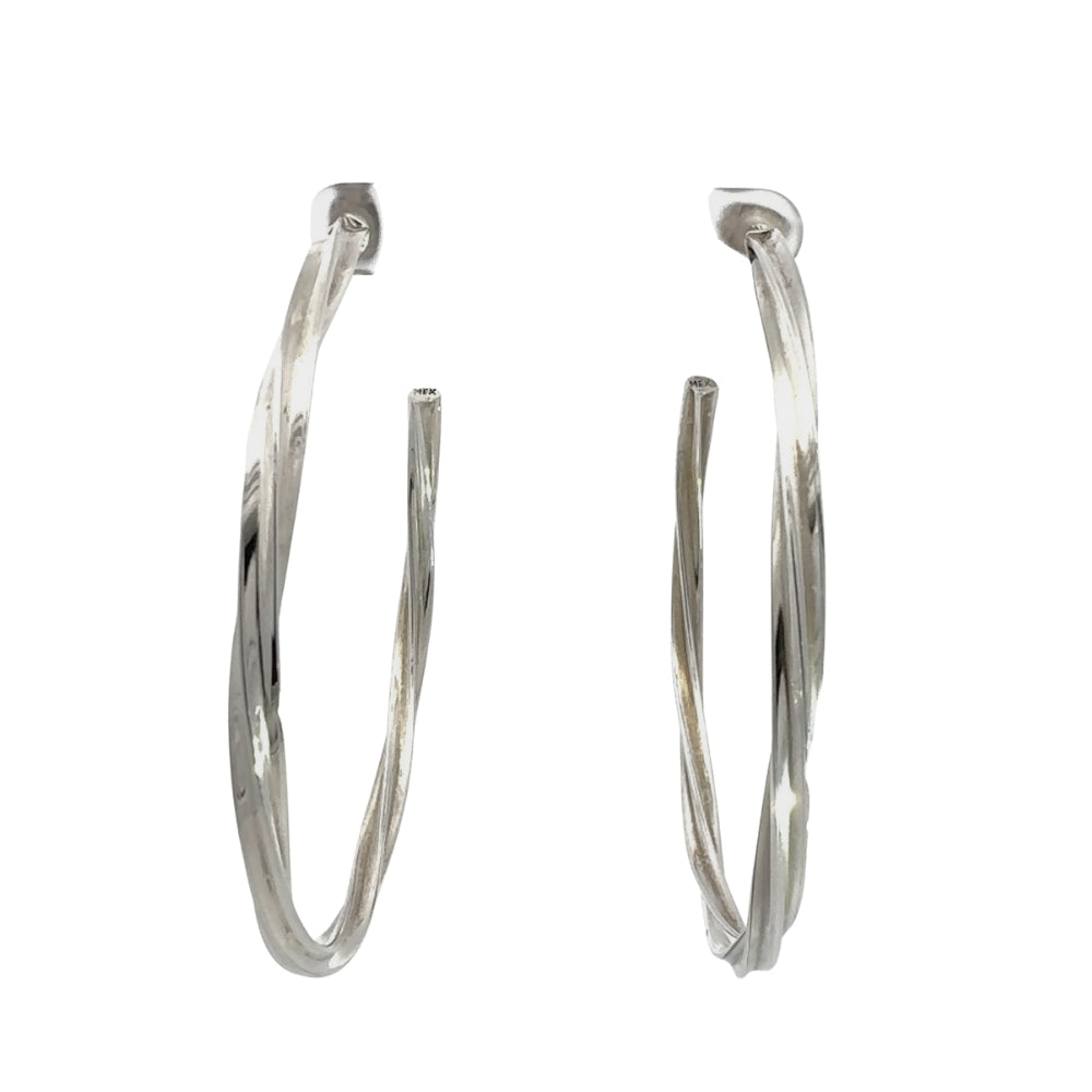 Pair of silver hoop earrings on a white background