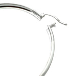 Silver hoop earring on a white background