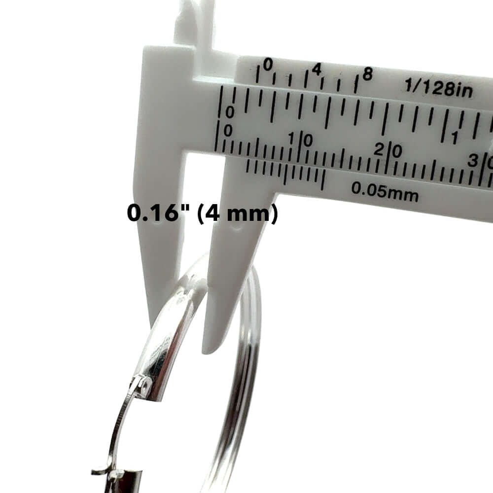 Close-up of a caliper measuring a silver hoop indicating 0.16" (4 mm) on a white background.