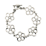 A silver flower link bracelet with a toggle clasp, displayed on a clean white background.