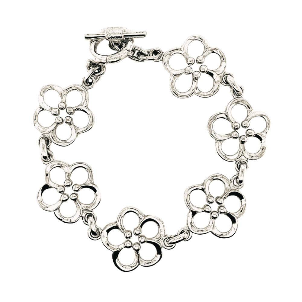 A silver flower link bracelet with a toggle clasp, displayed on a clean white background.