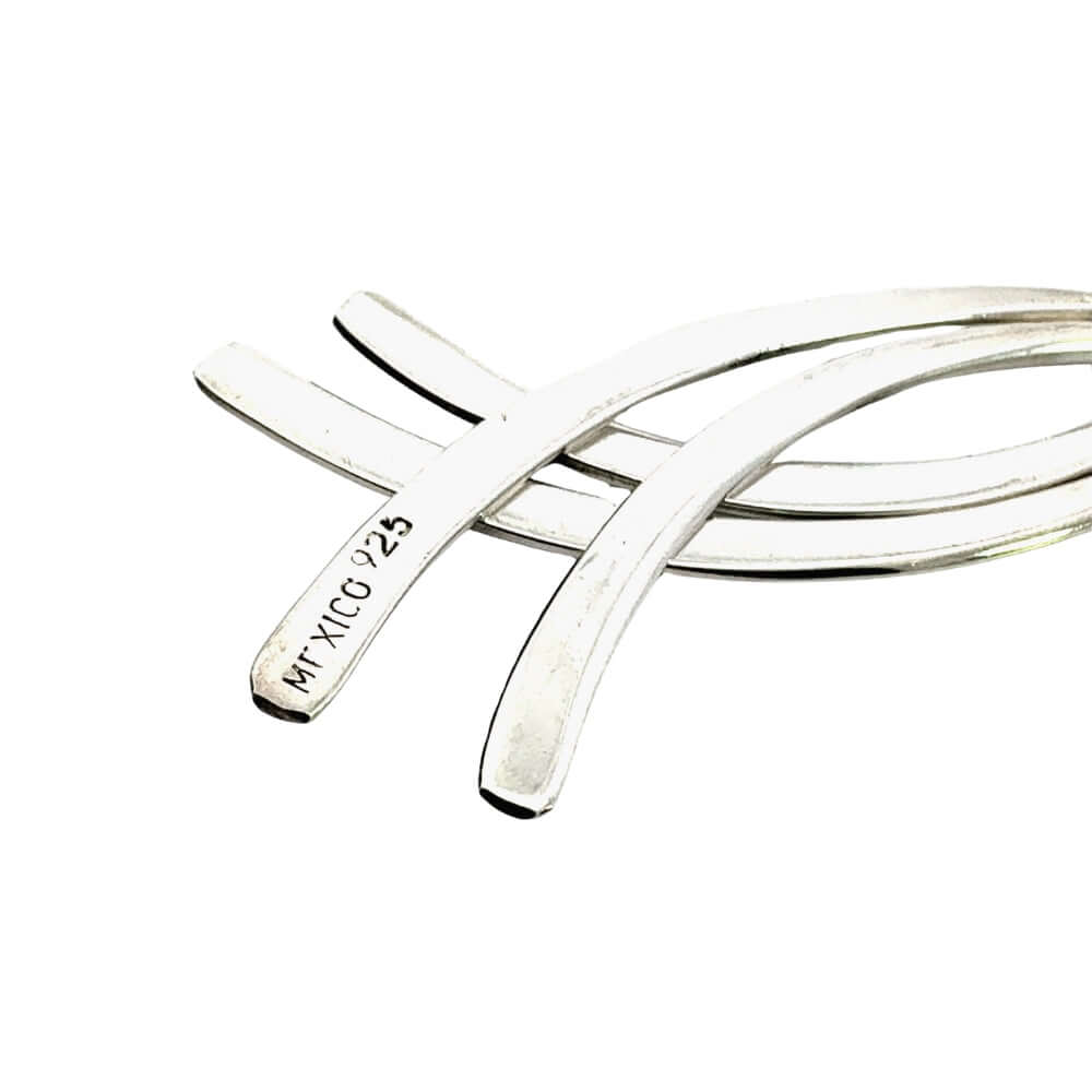 Silver earrings showing stamp on a white background