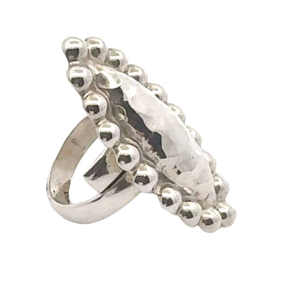 Silver ring with decorative design on a white background
