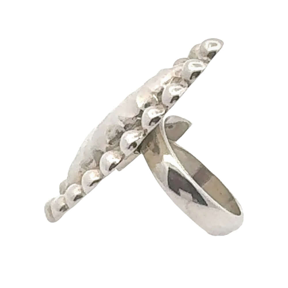 Silver ring with a textured design on a white background