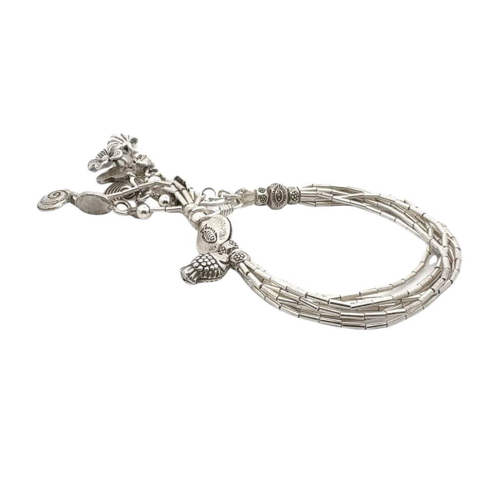 Silver bracelet with multiple strands and decorative elements on a white background