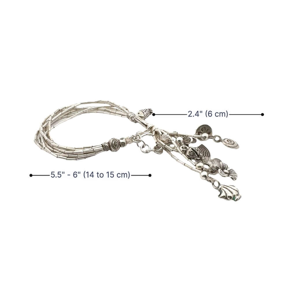 Silver bracelet with charms and measurements on a white background