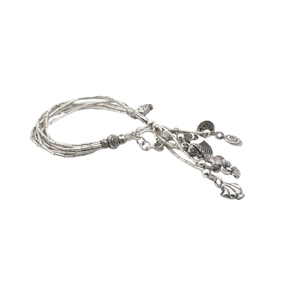 Silver bracelet with multiple braided wires and various charms on a white background