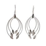Silver leaf-shaped earrings on a white background
