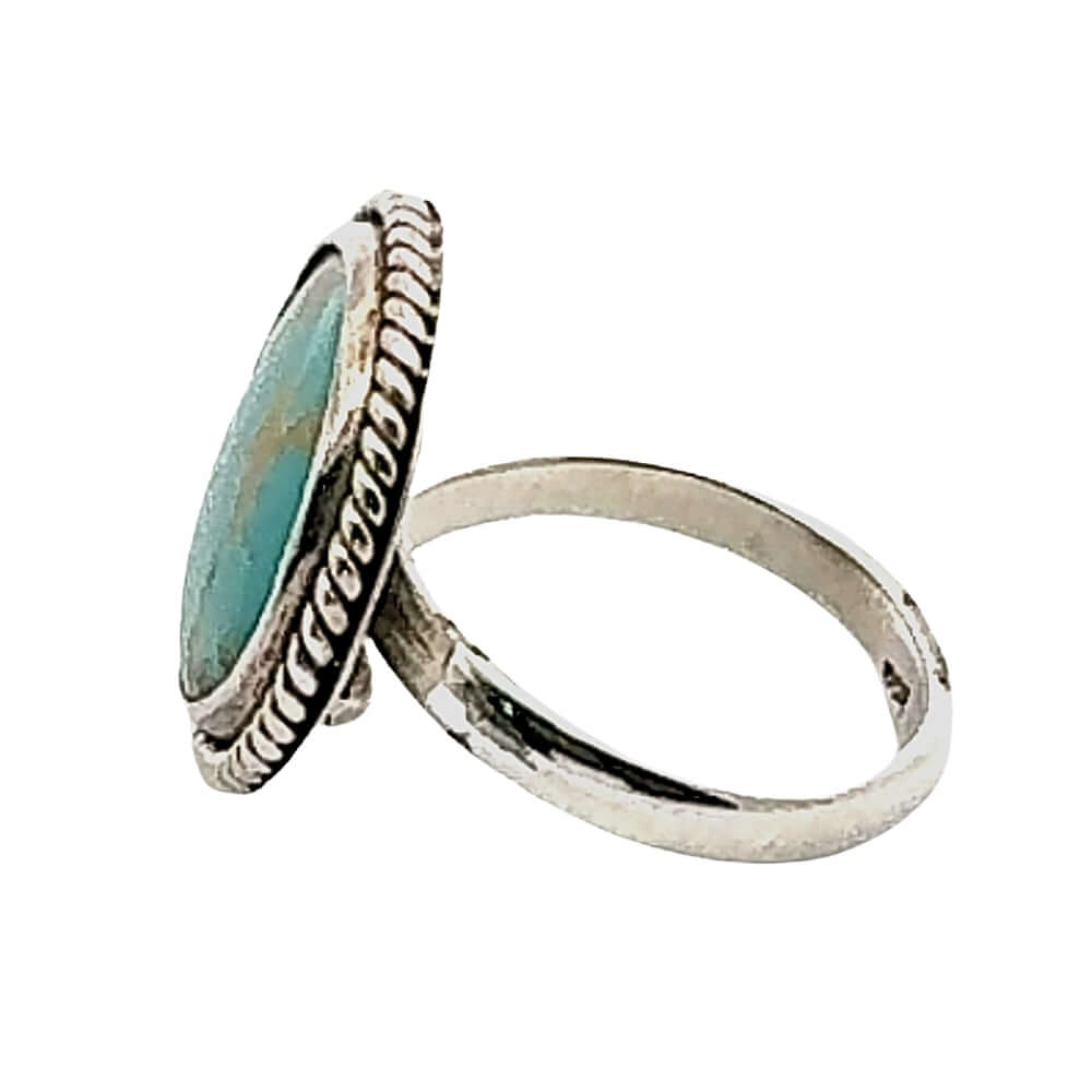 Silver ring with turquoise stone on a white background, side view