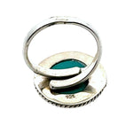 Silver ring with a green stone on a white background, hallmark