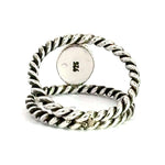 Silver twisted ring on a white background with 925 stamp