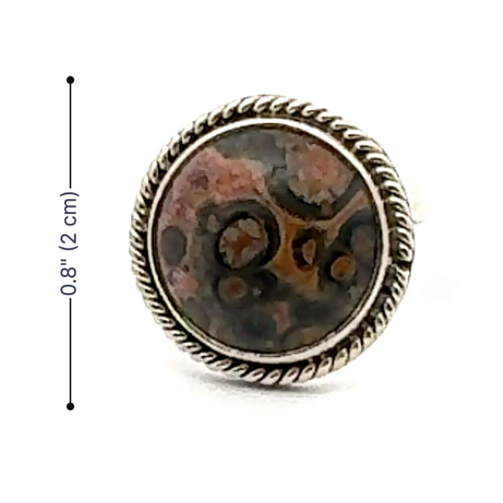 Round stone with decorative silver frame and measurement label on a white background