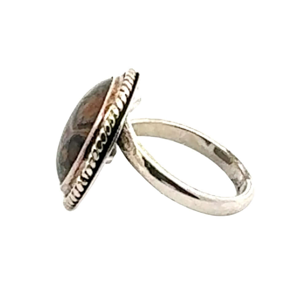 Silver ring with a stone inlay on a white background