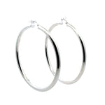 Pair of 6.5 cm silver hoop earrings on a white background