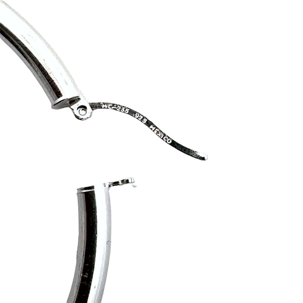 Silver hoop earring from Taxco close up to the s925 stamp on the closing clip