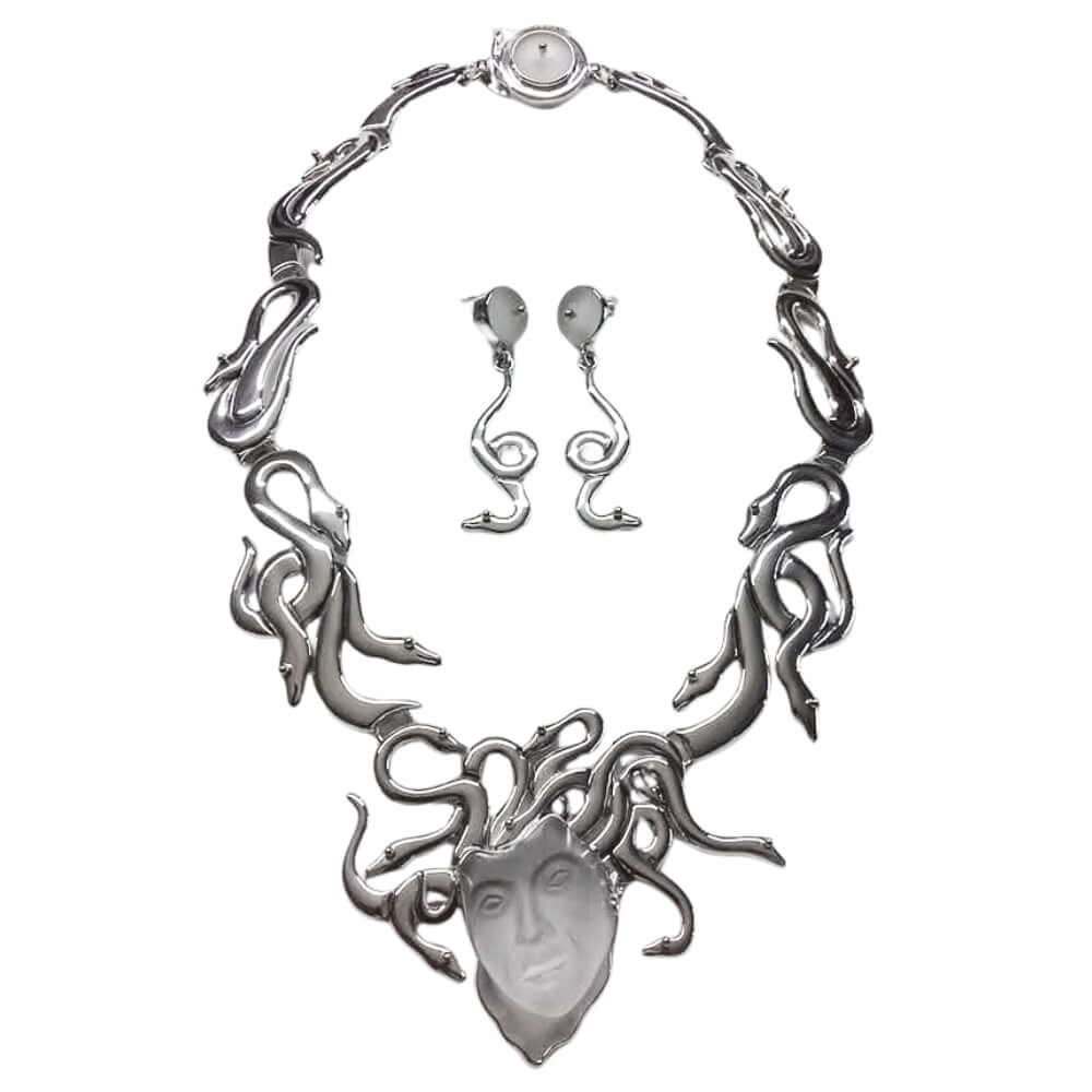 Silver necklace and earrings set on a white background