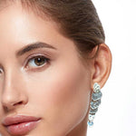 Close-up of a woman wearing a sparkling silver earring on a white background