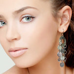 Close-up of a woman wearing a silver earring with multiple circles.