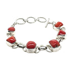 Silver bracelet with red coral' on a white background