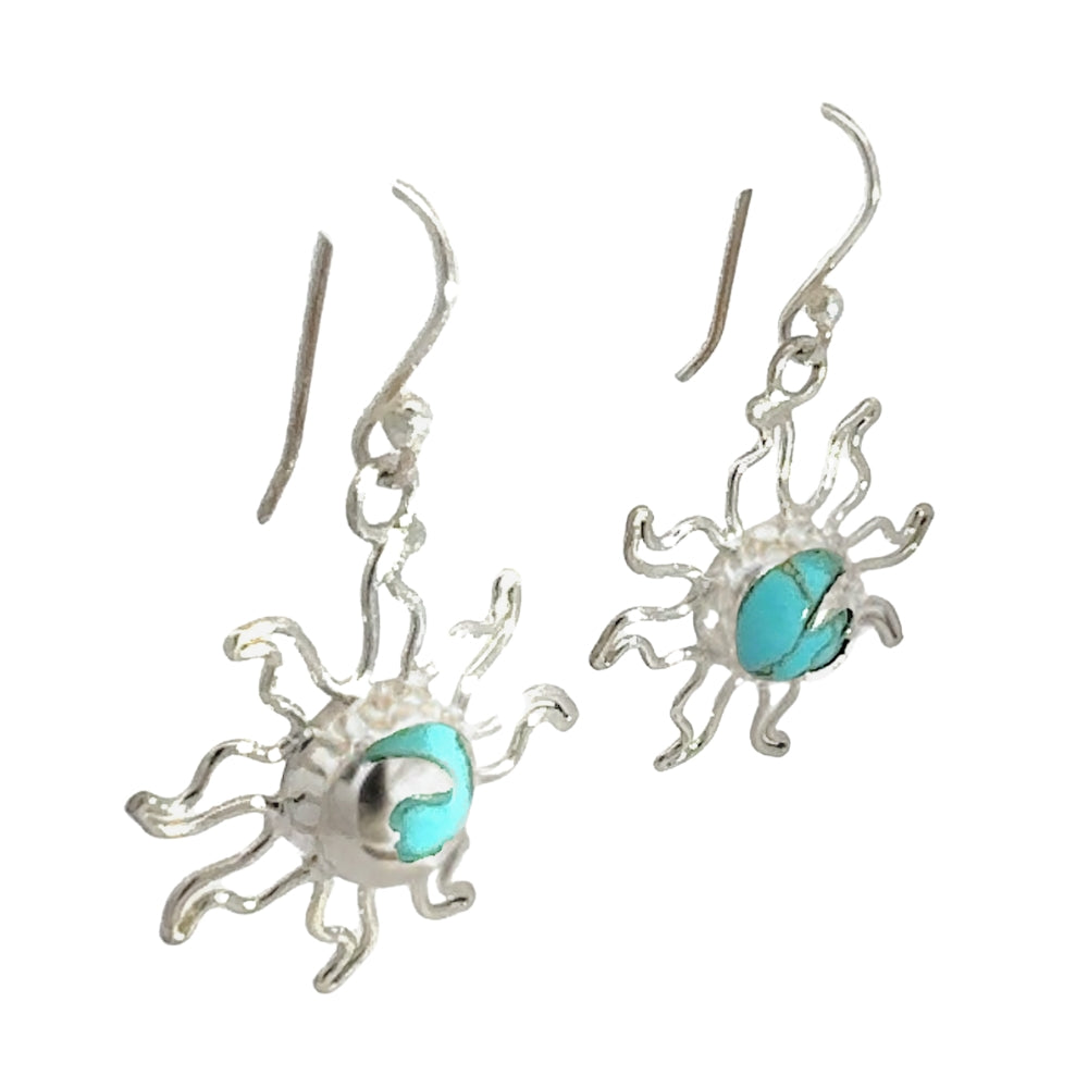 Silver eclipse earrings with turquoise centers on a white background
