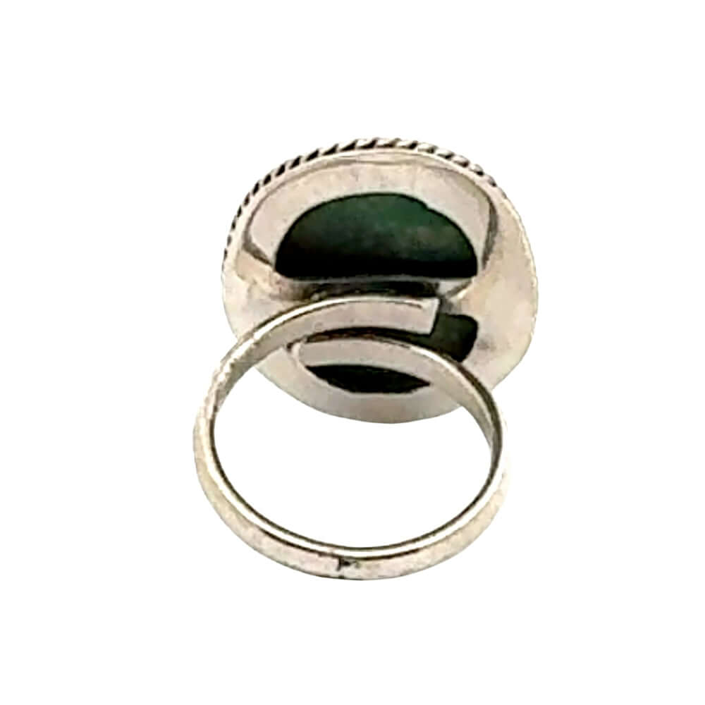 Silver ring with a green stone on a white background