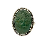 Ring with a green stone and silver band on a white background