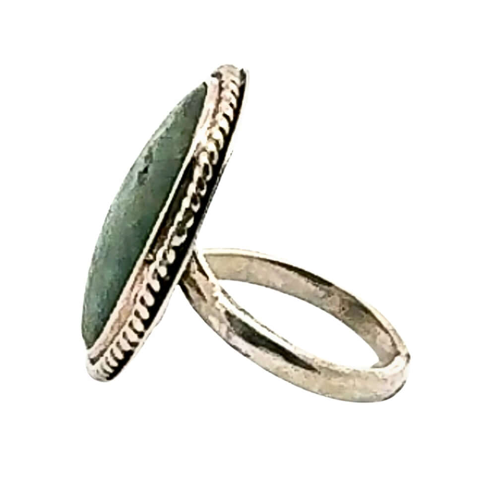 Silver ring with a green stone on a white background
