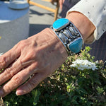 Navajo-Inspired-Blue-Turquoise-Leaves-Silver-Cuff-Bracelet-with-model-Nueve-Sterling