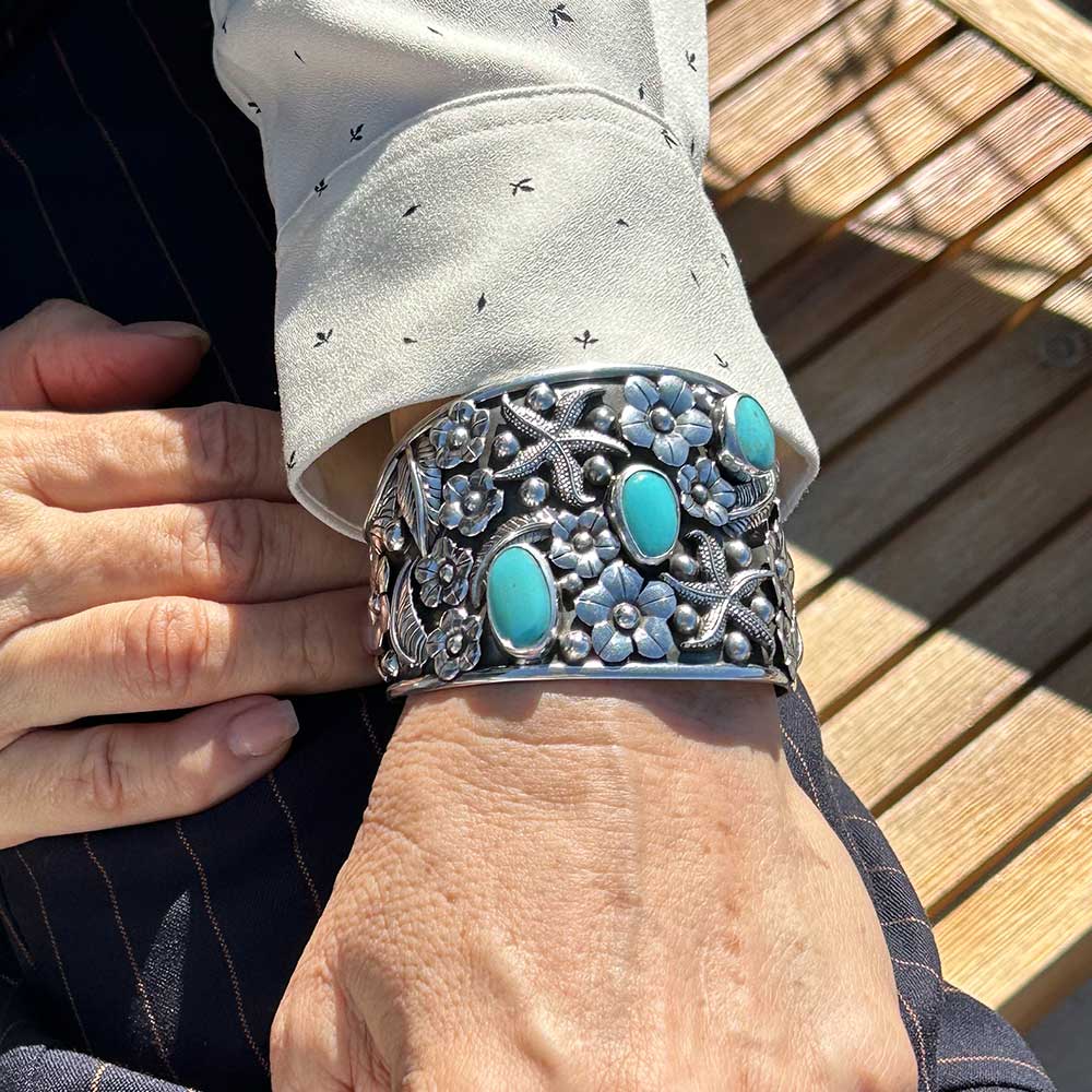 Navajo-Inspired-Turquoise-Floral-Silver-Cuff-Bracelet-with-model-Nueve-Sterling