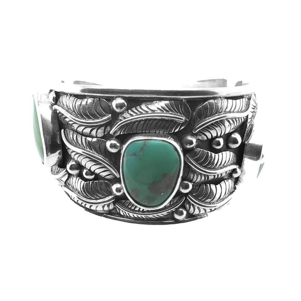 Front view of a wide handmade 925 sterling silver cuff bracelet featuring three green turquoise stones and detailed silver leaves.