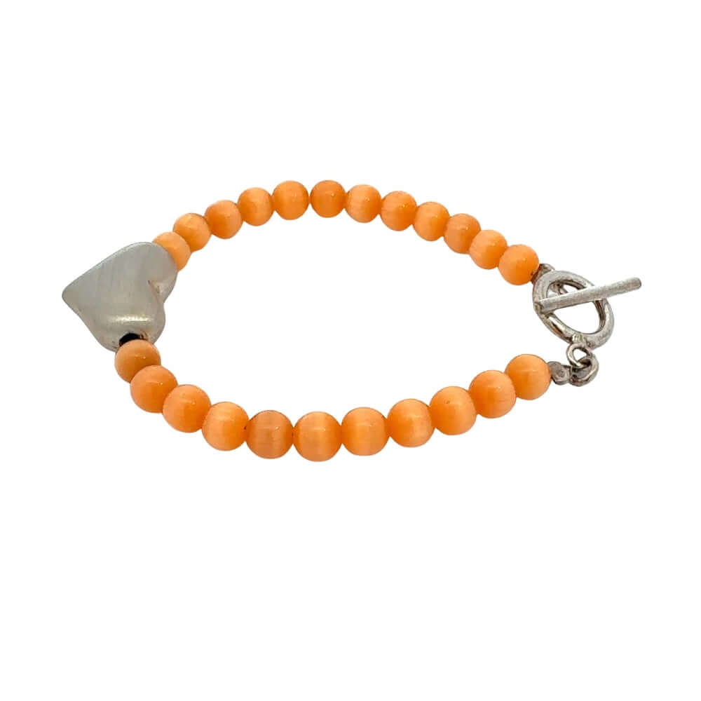 Orange cats eye beaded bracelet with silver heart on a white background