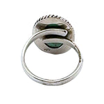 Silver ring with green stone on a white background
