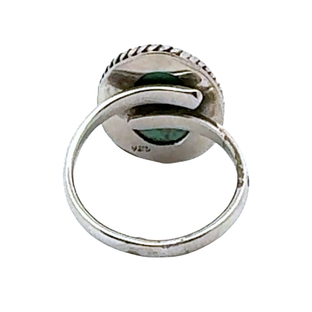 Silver ring with green stone on a white background