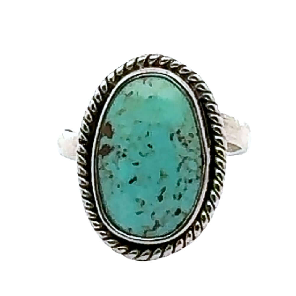 Turquoise ring with silver band on a white background
