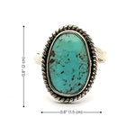 Turquoise ring with silver band and measurements on a white background