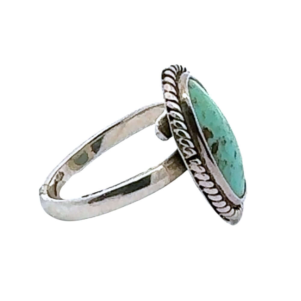 Silver ring with a turquoise stone on a white background
