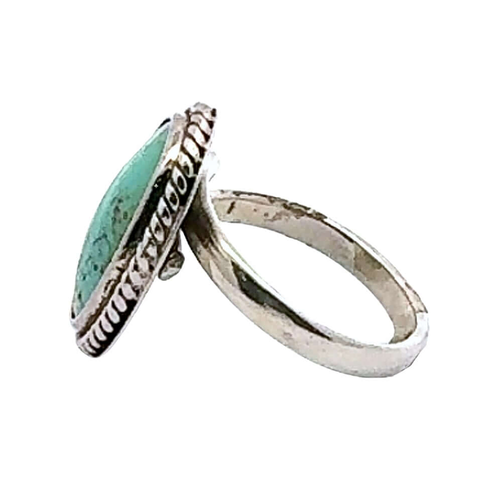 Silver ring with turquoise stone on a white background