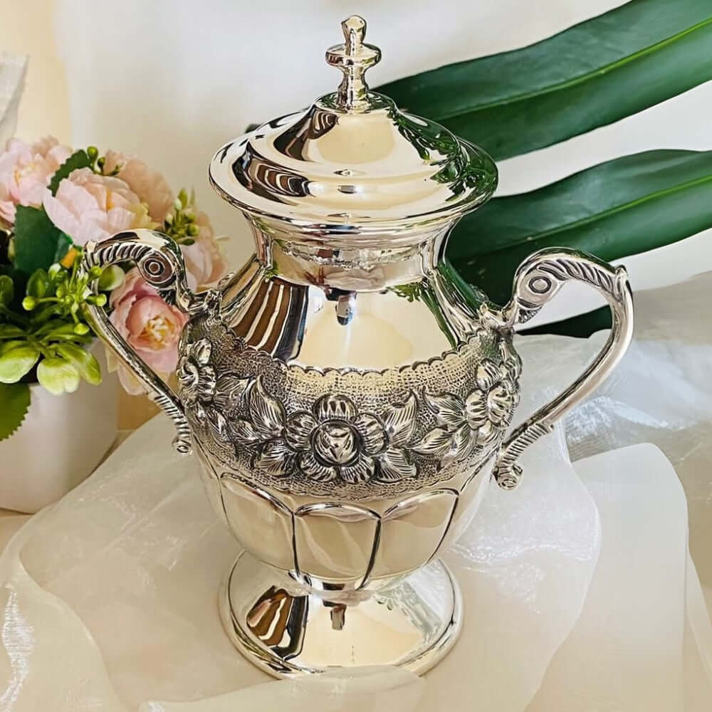 Handmade Taxco silver relicario urn with repoussé detailing by artisan Alejandro Fajardo, designed to hold ashes and preserve memories.