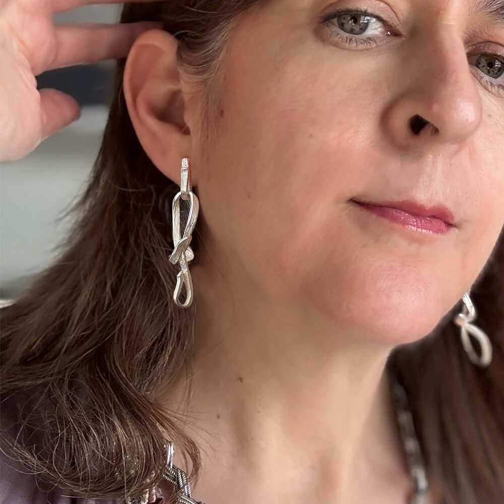 Silver-Twisted-Long-Dangle-Post-Earrings-with-model-Nueve-Sterling
