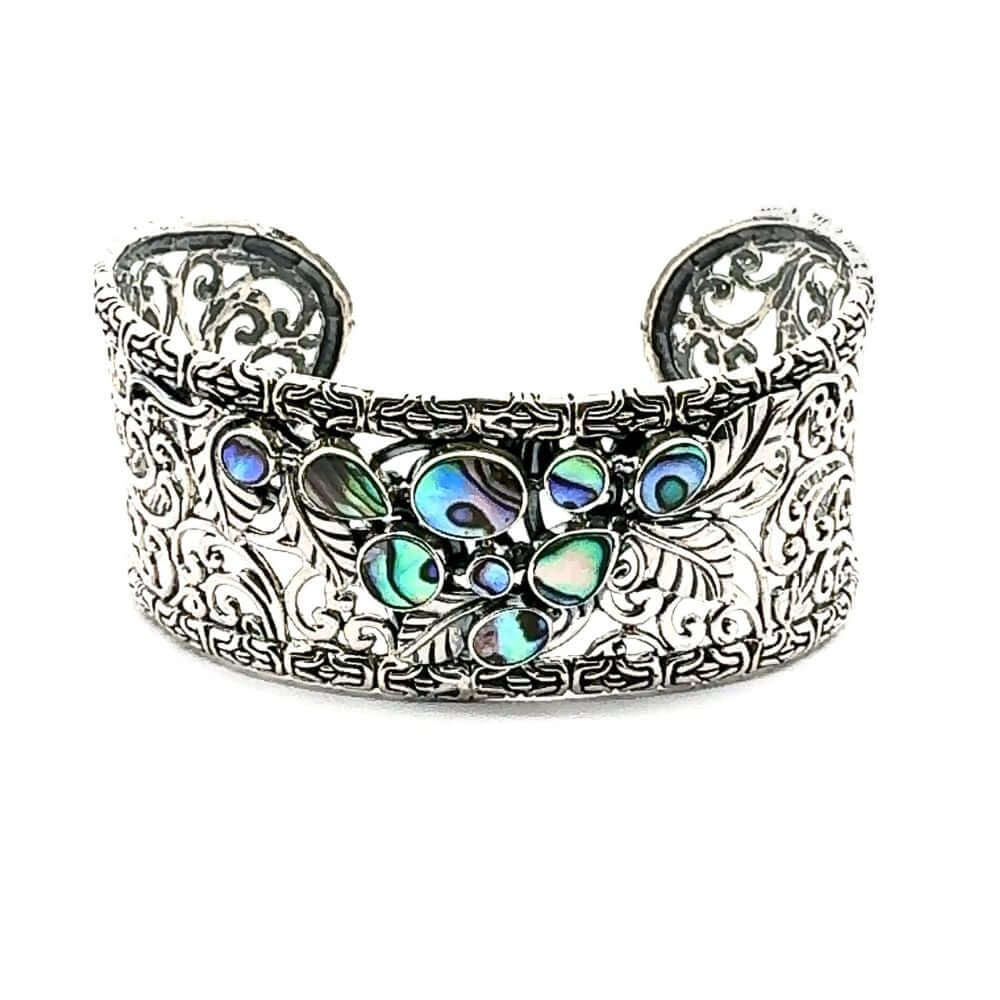 Decorative silver cuff-bracelety with colorful abalone on a white background
