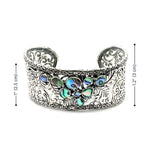 Silver cuff bracelet with colorful abalone and measurements on a white background